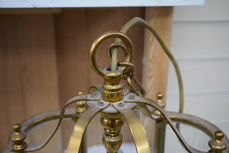 A brass and glass three light hall lantern, 44cm high. Condition - good